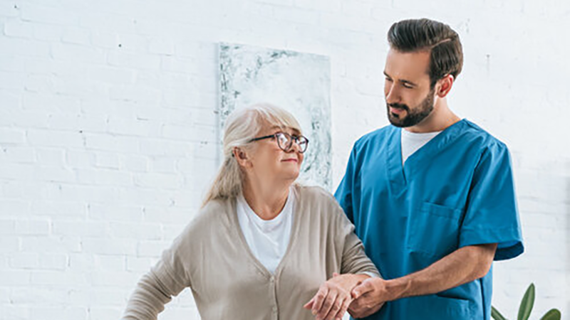 A healthcare professional assisting a senior person